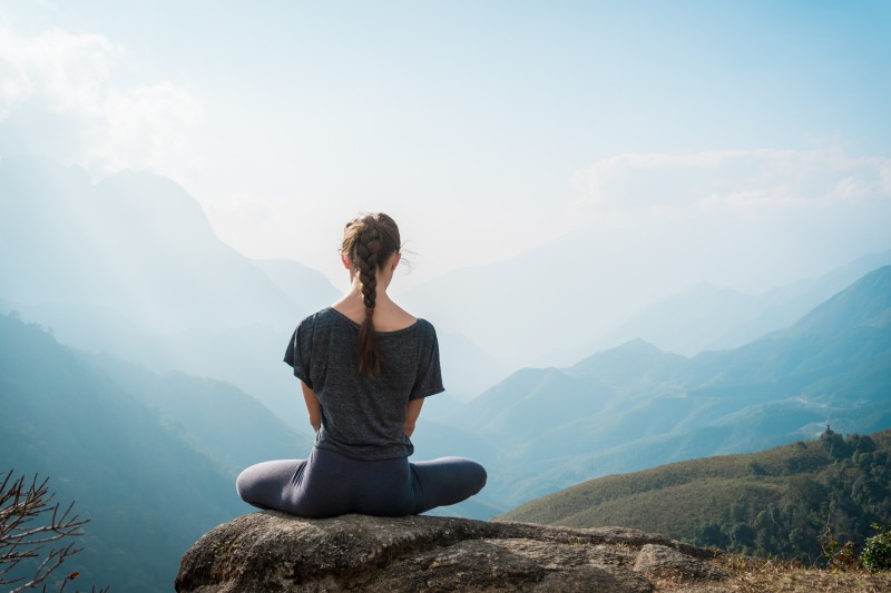 Women meditating in the mountains